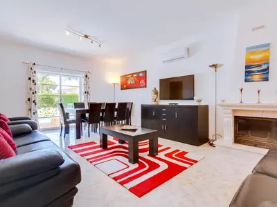 a living room with a couch and a table at AL Casa Raha in Quinta do Lago
