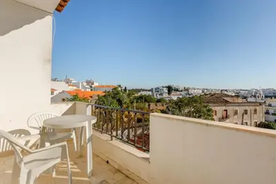 a balcony with a table and chairs and a view at Appartement Albufeira in Albufeira