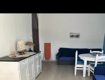 a living room with a table and a blue couch at Appartement Albufeira in Albufeira