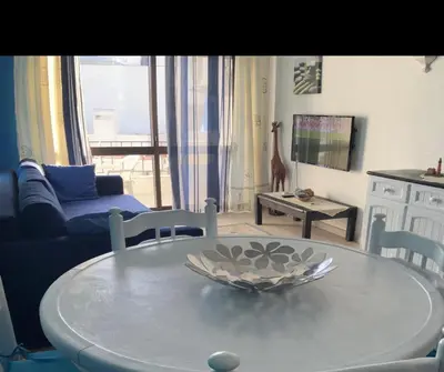 a living room with a table and a couch at Appartement Albufeira in Albufeira