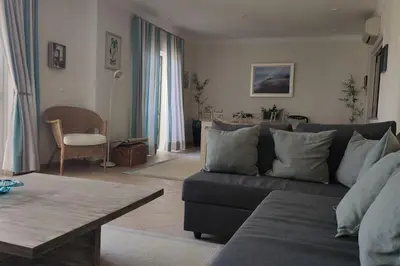 a living room with a couch and a table at Private luxury apartment Vale do Lobo in Almancil