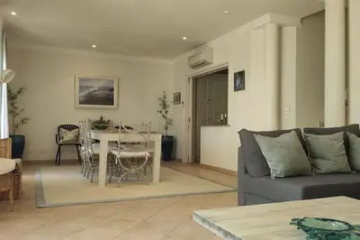 a living room with a couch and a table at Private luxury apartment Vale do Lobo in Almancil