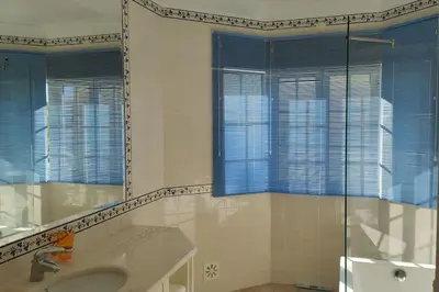 a bathroom with a shower and a sink and a mirror at Private luxury apartment Vale do Lobo in Almancil