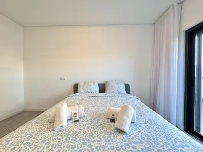 a bedroom with a bed with two towels on it at Faro Prestige by Homing in Faro