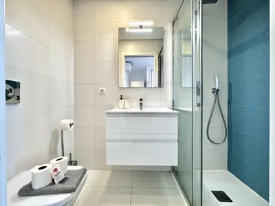 a bathroom with a glass shower and a sink at Faro Prestige by Homing in Faro