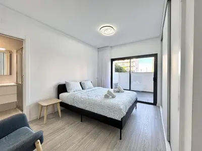 a bedroom with a bed and a large window at Faro Prestige by Homing in Faro