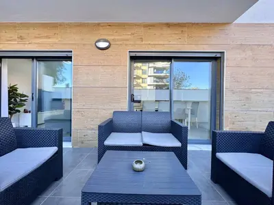 a patio with two chairs and a coffee table at Faro Prestige by Homing in Faro