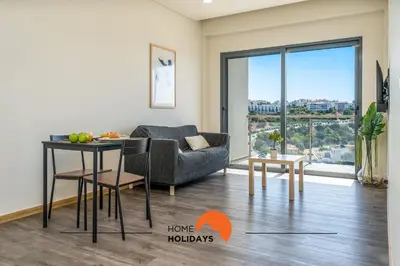 a living room with a couch and a table at #233 Fox Trail by Home Holidays in Albufeira