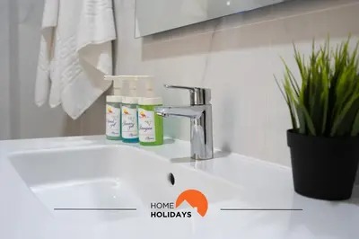a bathroom sink with two bottles of toothpaste on it at #233 Fox Trail by Home Holidays in Albufeira