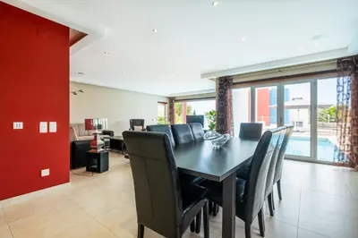 a dining room with a black table and chairs at Capetown Marina Luxury Villa - Private Pool in Albufeira