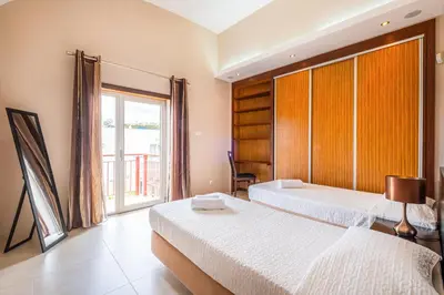 a bedroom with two beds and a large window at Capetown Marina Luxury Villa - Private Pool in Albufeira