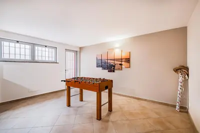 a room with a table and a painting on the wall at Capetown Marina Luxury Villa - Private Pool in Albufeira