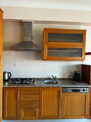 a kitchen with a sink and a stove at Albufeira Appartement avec piscine in Albufeira