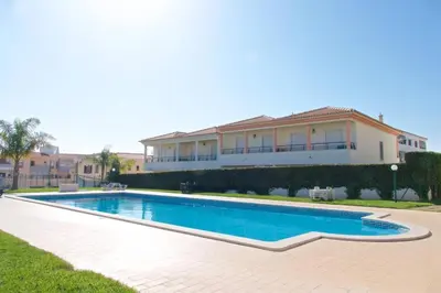 a swimming pool in front of a house at Albufeira Appartement avec piscine in Albufeira
