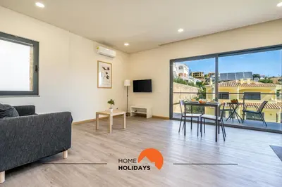 a living room with a couch and a table at #234 Serenity Refuge w Balcony and Pool in Albufeira