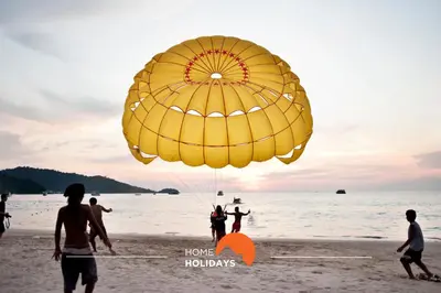 a group of people on the beach with a large yellow parachute at #234 Serenity Refuge w Balcony and Pool in Albufeira