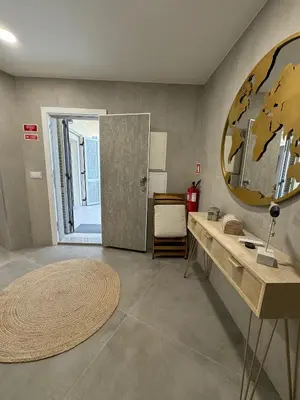 a bathroom with a large mirror and a sink at Marina Gemeos - Vilamoura Center by HD Properties in Vilamoura