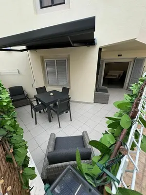 a patio with a table and chairs and a table at Marina Gemeos - Vilamoura Center by HD Properties in Vilamoura