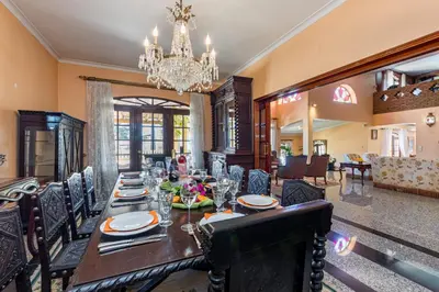 a dining room with a long table and a chandelier at Villa Sobreiro in Albufeira