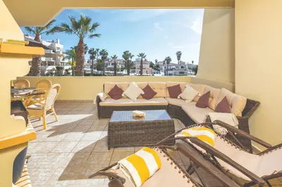 a large apartment building with a lawn in front of it at Stylish 2BR Apartment with Pool Parking & WiFi in Albufeira