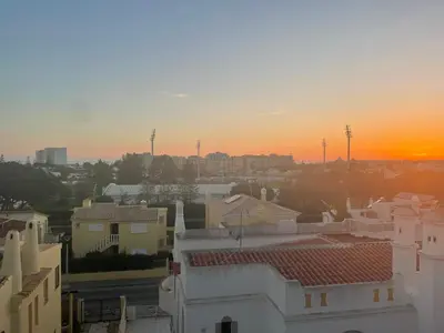a sunset over a city with houses and buildings at Vilamoura 10 in Quarteira