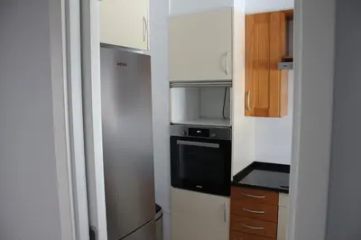 a small kitchen with a stove and a refrigerator at Vilamoura 10 in Quarteira