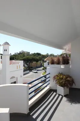 a white balcony with a view of a street at Vilamoura 10 in Quarteira