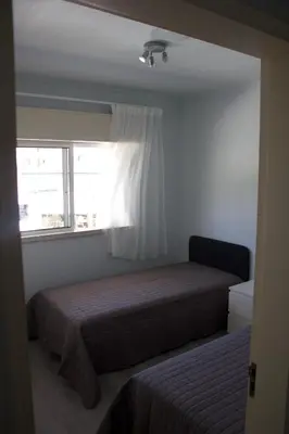 a small bedroom with a bed and a window at Vilamoura 10 in Quarteira