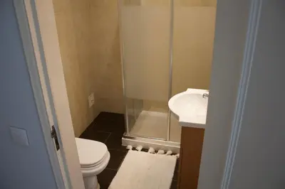 a bathroom with a shower and a toilet and a sink at Vilamoura 10 in Quarteira