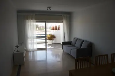 a living room with a couch and a table at Vilamoura 10 in Quarteira