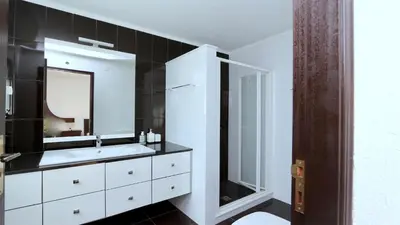 a bathroom with a white sink and a mirror at Villa Lotus, CD 283 - Cleverdetails in Vilamoura