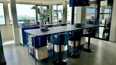 a kitchen with a island with chairs and a counter top at Vilamoura in Quarteira