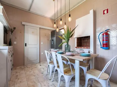 a dining room with a table and chairs at Walk in Hostel Faro Airport in Faro