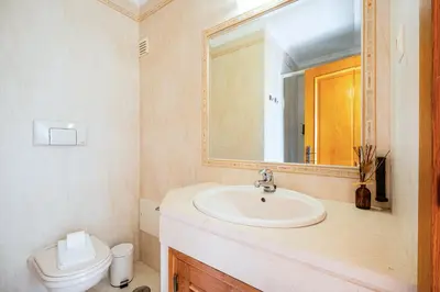 a bathroom with a sink and a toilet at Villa Gil in Albufeira
