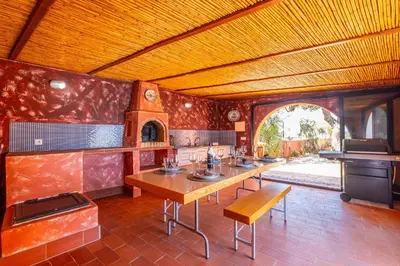 a dining room with a table and a stove at Orange Tree House in Albufeira
