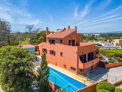an aerial view of a house with a swimming pool at Orange Tree House in Albufeira