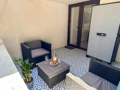 a white building with palm trees in front of it at BnB Homes Falésia Beach cozy Apartment with terrace & 2 Swimming Pools in Roja- Pé