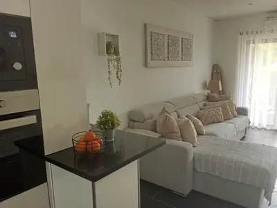 a living room with a couch and a table at ADO HOUSE Albufeira in Albufeira