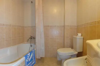 a bathroom with a toilet and a tub and a sink at Apartamento Avenida da Liberdade in Albufeira