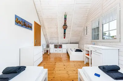 a room with two beds and a desk at Villa Oliva - Maison 6 chambres in Vilamoura