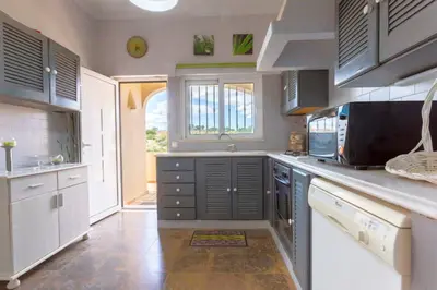 a kitchen with gray cabinets and a counter top at Villa Matibora by HelloVacations in Albufeira