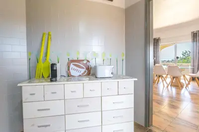 a room with a white dresser with baseball equipment on it at Villa Matibora by HelloVacations in Albufeira