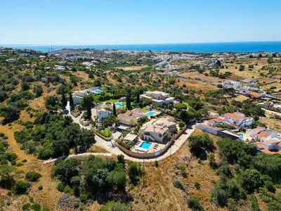 an aerial view of a house on a hill next to the ocean at Villa Matibora by HelloVacations in Albufeira