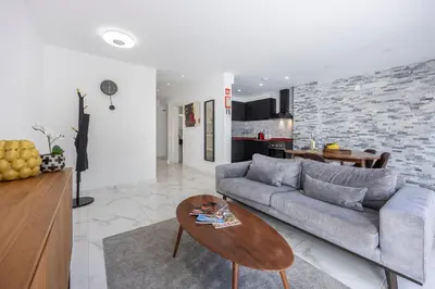 a living room with a couch and a table at Casa Verde Vilamoura in Quarteira