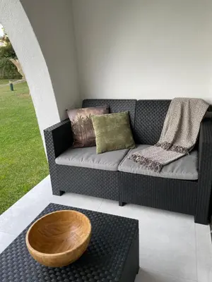 a living room with a couch and a wooden table at Modern Apartment with balcony and direct access to the pool in Albufeira