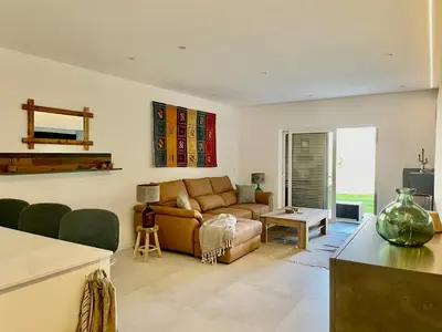 a living room with a couch and a table at Modern Apartment with balcony and direct access to the pool in Albufeira