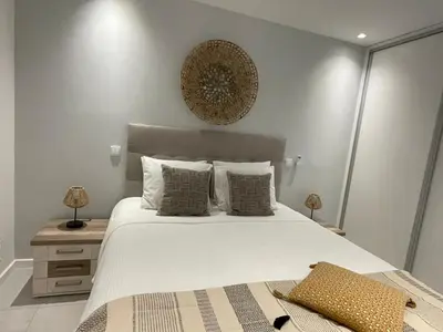 a bedroom with a large white bed with pillows at Modern Apartment with balcony and direct access to the pool in Albufeira