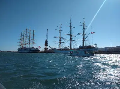 two tall ships are docked in a harbor at Beach Front Luxury T1 Apt Pools Garage Tennis in Albufeira
