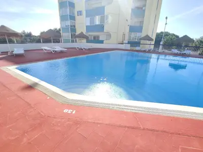 a large swimming pool in front of a building at Happy&Roses, Vilamoura, pool&golf in Vilamoura