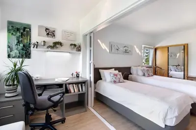 a bedroom with two beds and a desk with a computer at Happy&Roses, Vilamoura, pool&golf in Vilamoura